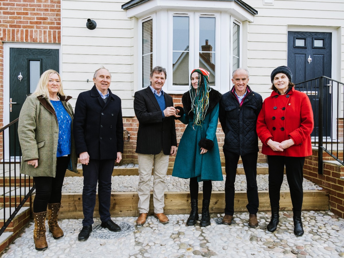 Cllr Jessie Carter, Babergh District Council Housing cabinet member receives the keys to eight new homes in Lavenham from Malcolm Payne, Harthog Hutton Director with Chair of Lavenham Parish Council, Janice Muckian, Babergh Council deputy leader, Cllr John Ward, and ward councillors Paul Clover and Margaret Maybury