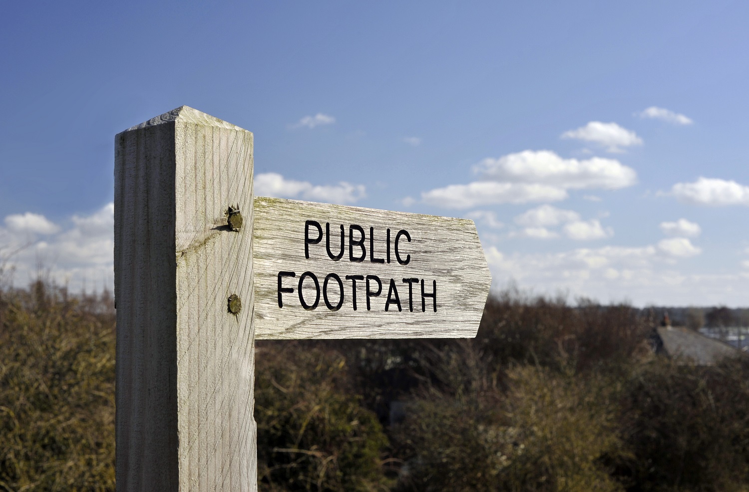 Sign pointing to a public footpath